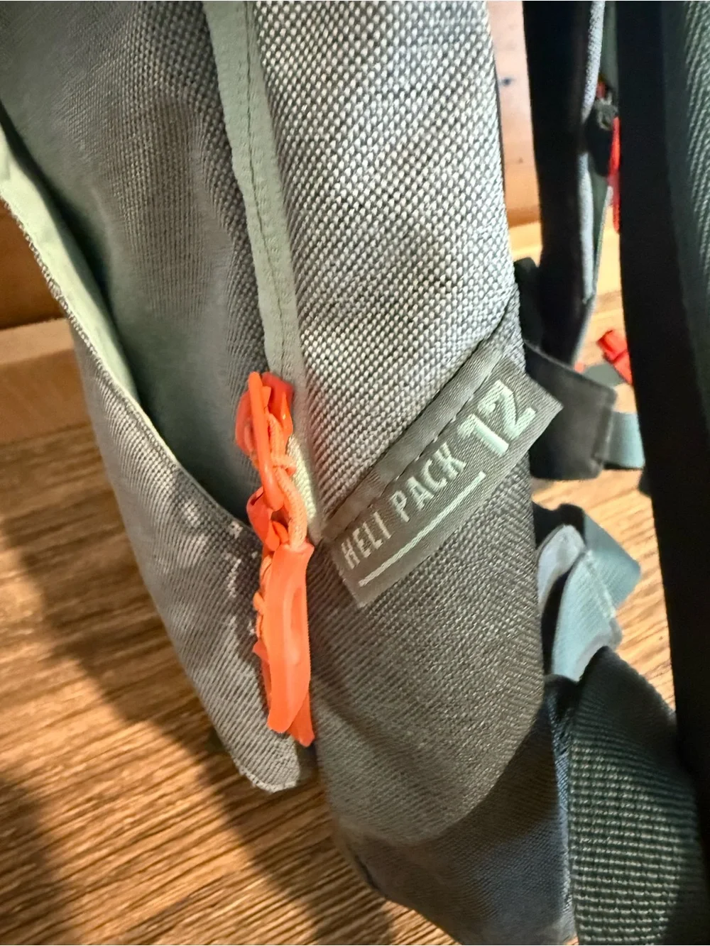 Dakine Mint tinted heli pack 12 backpack with Orange Buckles